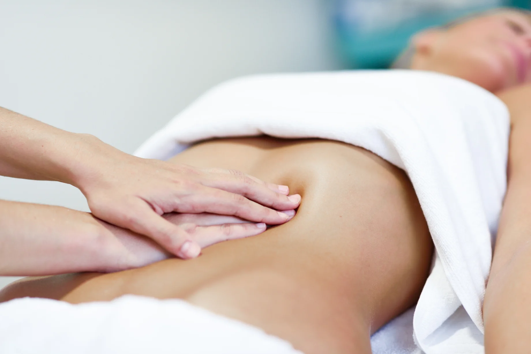 hands-massaging-female-abdomen-therapist-applying-pressure-belly