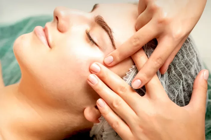 young-woman-receiving-facial-massage-by-hands-in-spa-medical-salon
